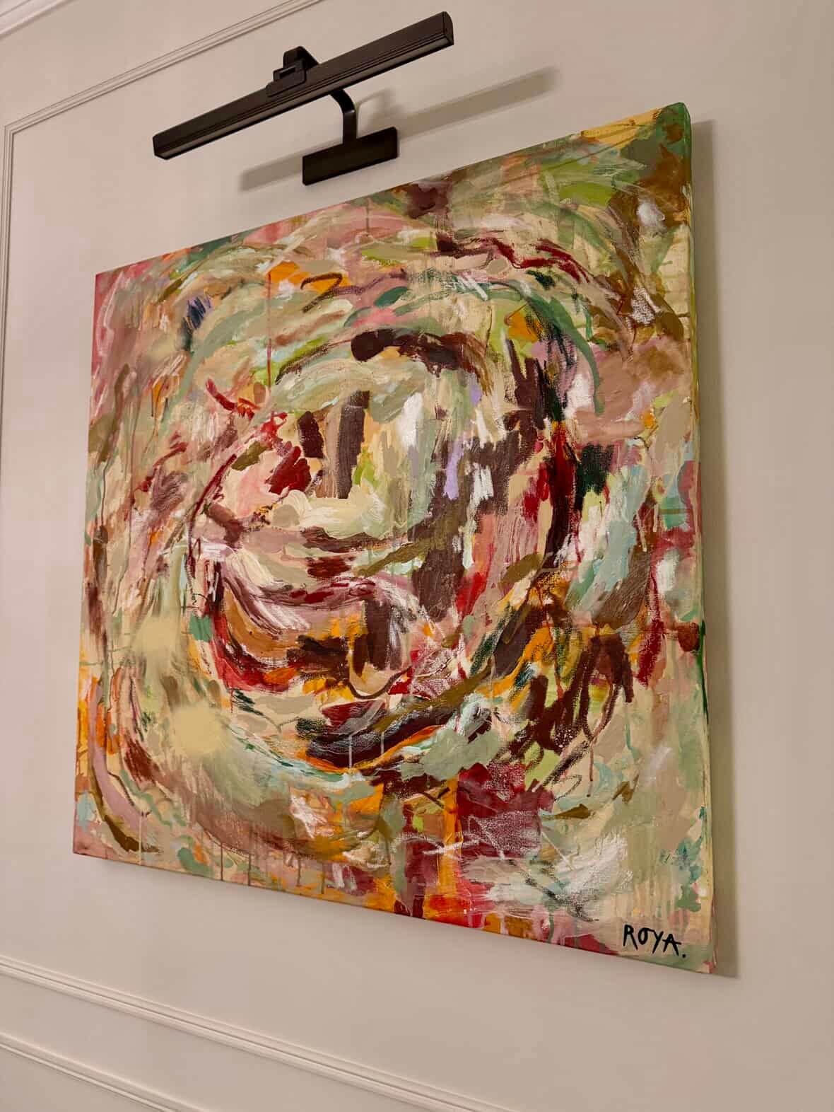 Abstract painting on a wall with a light gray background