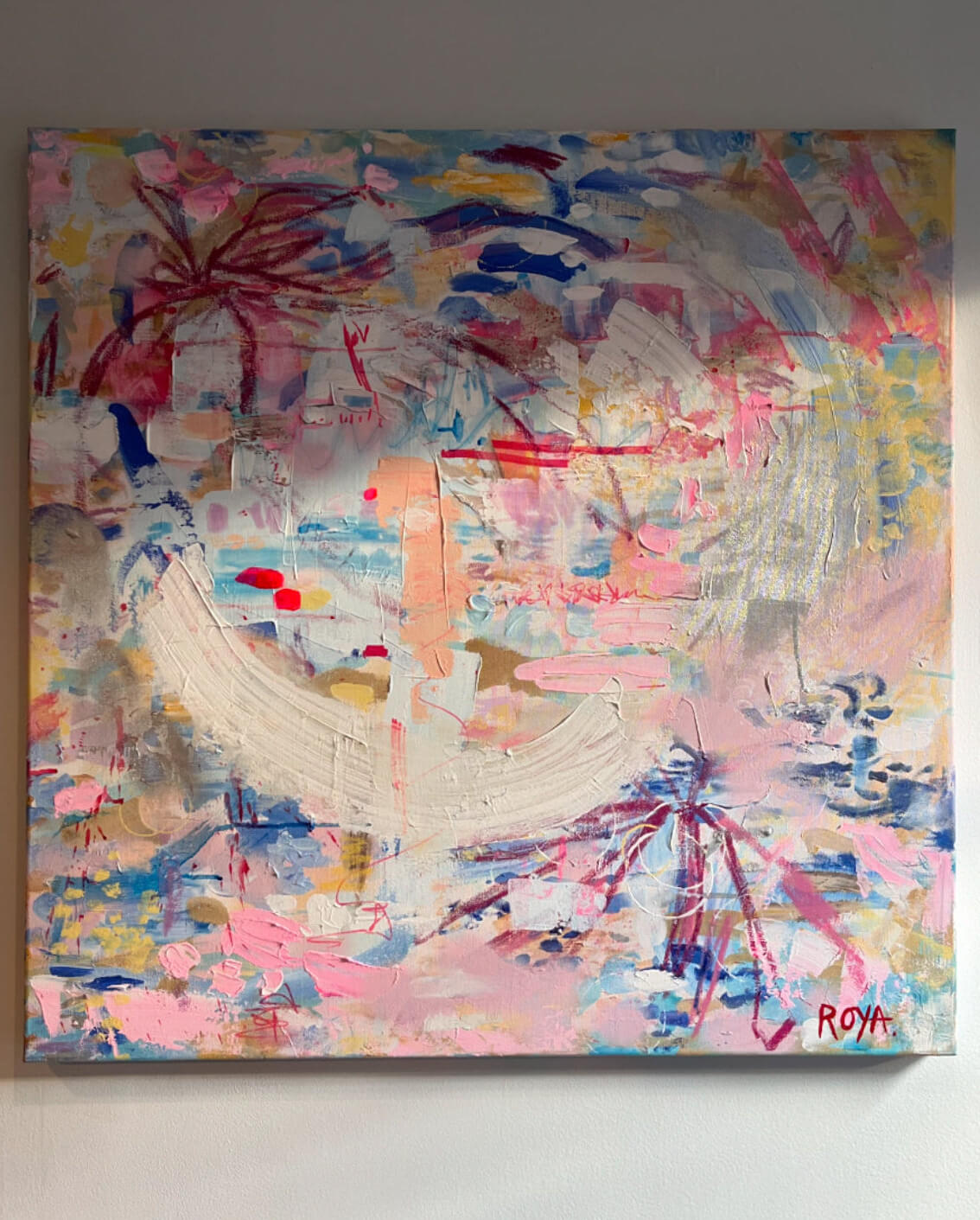 Abstract painting with vibrant colors on a white wall